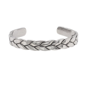Detailed close-up of retro silver woven texture on a stainless steel open cuff bracelet