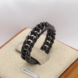 Men's black Cuban chain ring in stainless steel with crystal accents on a jewelry stand