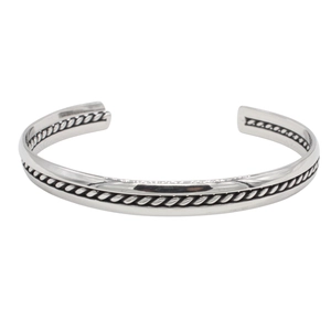 Detail of vintage silver titanium steel open cuff bracelet with rope twisted pattern