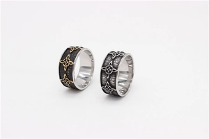 Detail view of retro Celtic knot rings in gold and silver finish with matte black accents