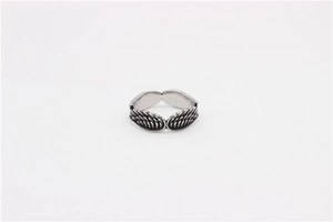 Detailed view of the intricate feather wing texture on a vintage steel ring band