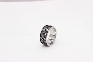 Detail of vintage Celtic knot engraving on men's matte titanium steel wide band ring