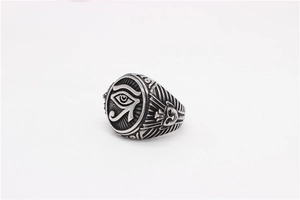 Detailed relief of the Eye of Horus and Egyptian mask on vintage stainless steel ring
