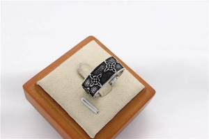 Macro detail of retro Celtic knot embossed pattern on wide titanium steel ring