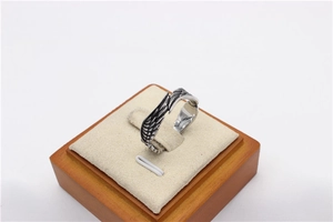 Macro shot of vintage titanium steel ring featuring detailed angel wing feather textures