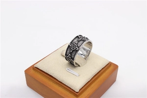 Close-up of vintage men's stainless steel ring with Celtic knot relief and oxidized finish
