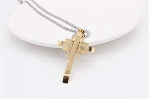 Macro shot of minimalist gold geometric cross pendant with silver metal chain necklace