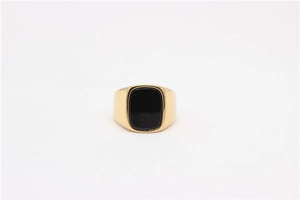 Detailed close-up of a gold-plated men's ring with a rectangle black onyx gemstone