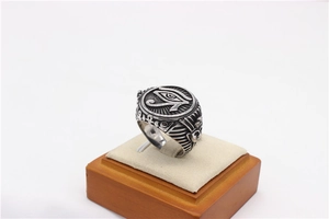 Macro detail of vintage Egyptian Eye of Horus and Pharaoh engraving on titanium steel ring