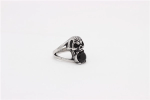 Macro view of vintage punk skull ring with detailed black octagon gemstone inlay