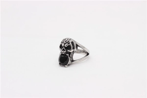 Detailed close-up of a vintage skull ring with a black gemstone in the mouth