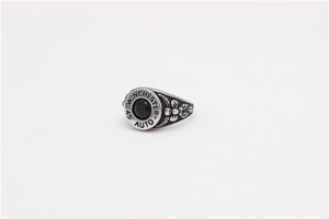 Macro shot of silver vintage bullet ring with black stone and flower carvings