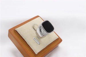 Macro detail of men's titanium steel ring featuring a large rectangular black gemstone