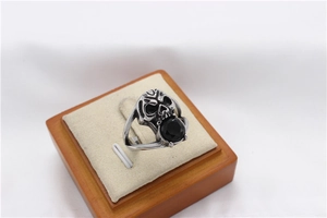 Macro detail of gothic skull ring with black faceted gemstone in vintage steel finish