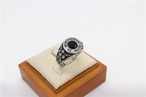 Macro shot of retro steel ring featuring Winchester 45 Auto bullet design and black gemstone