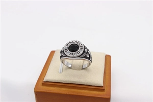 Macro detail of retro steel ring with black gemstone and engraved Winchester bullet base
