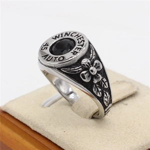 Retro stainless steel ring with black gemstone and floral embossed vintage finish