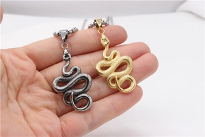 Detail of snake pendant showing realistic scales in vintage silver and gold finishes