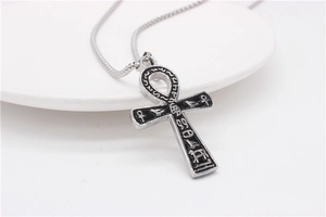Detailed macro of vintage Egyptian Ankh cross pendant with ancient hieroglyphic engravings