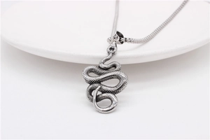 Detailed close-up of retro snake pendant with realistic scale texture and snake chain