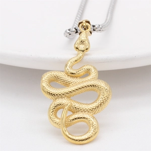 Vintage gold snake pendant necklace with textured scales on a silver ball chain