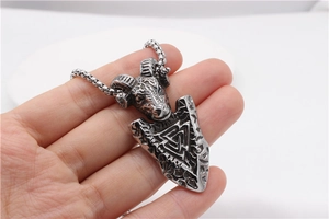 Macro view of vintage Viking ram shield pendant in steel with Valknut engraving