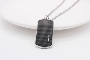 Detailed macro of men's silver dog tag pendant with black grid inlay and five zircons