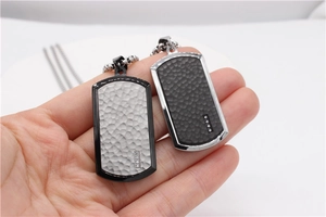 Detail of hammer-textured military dog tag pendants with zircon inlay and bead chains