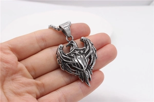 Macro view of vintage eagle shield pendant with detailed wings and steel chain