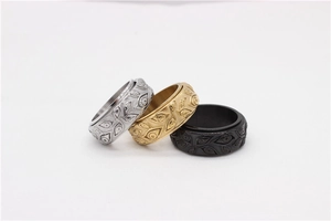 Detail of spinning stainless steel rings with All-Seeing Eye relief in gold, silver, and black