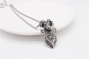 Macro detail of retro Viking ram head pendant with Valknut symbol on stainless steel chain