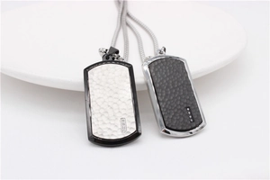 Detail of dog tag pendants with hammer texture, zircon inlay and steel ball chains