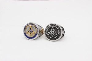 Macro shot of two Masonic rings with blue and black enamel details and G symbol engraving