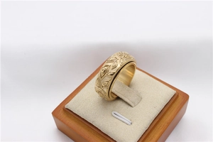 Macro shot of gold spinner ring featuring embossed Egyptian All-Seeing Eye patterns