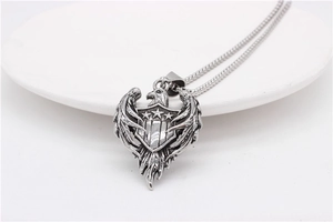 Detail shot of vintage eagle shield pendant with stars on stainless steel ball chain