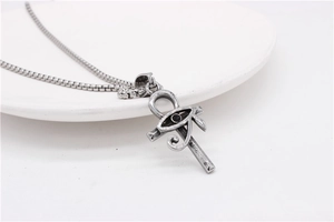Detail of vintage Eye of Horus Ankh cross pendant on a square box chain link