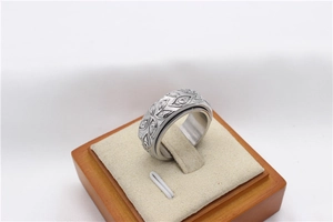 Macro shot of rotatable stainless steel ring with Pharaoh Eye relief patterns