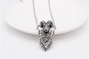Detail of Viking ram head pendant with Valknut symbol in vintage stainless steel finish