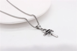 Detail of vintage Eye of Horus and Ankh cross pendant on a silver box chain necklace