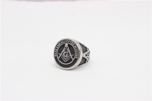Detailed macro view of silver Masonic ring with Freemason symbol and compass engraving