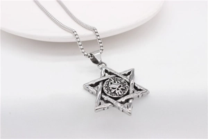 Detail of vintage steel punk pendant featuring hexagram flame skull on a box chain