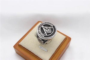 Macro shot of Freemason signet ring showing the square and compass engraved detailing