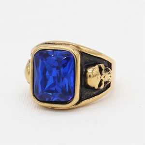 Vintage gold skull ring for men featuring a large rectangular blue gemstone center