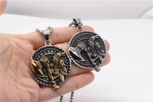 Detailed close-up of Viking pendants with axes and ravens in silver and gold finishes