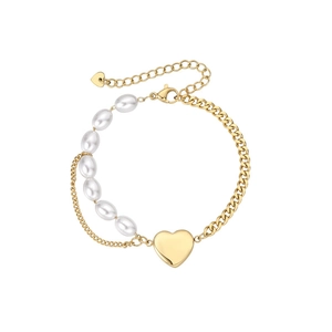 Detailed close-up of double-layer gold chain bracelet with pearls and large heart charm