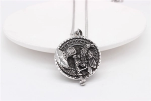 Detail shot of Viking pendant with eagle, battle axe, and Valknut symbols on ceramic