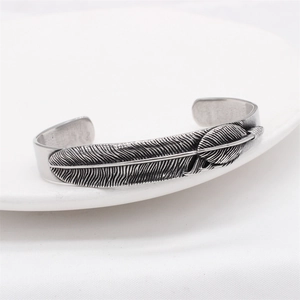 Vintage stainless steel feather cuff bracelet with detailed antique silver engraving