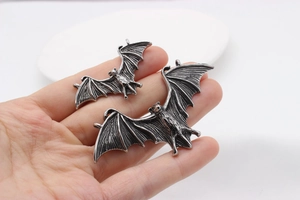 Gothic bat wing pendants in two sizes with realistic wing texture on hand display