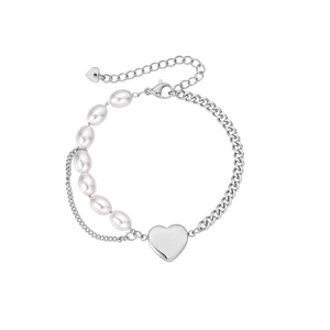 Detail of pearl and silver chain bracelet featuring a polished heart pendant on white background