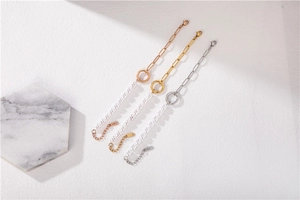 Detailed macro view showing rose gold, gold, and silver pearl bracelets with lobster clasps